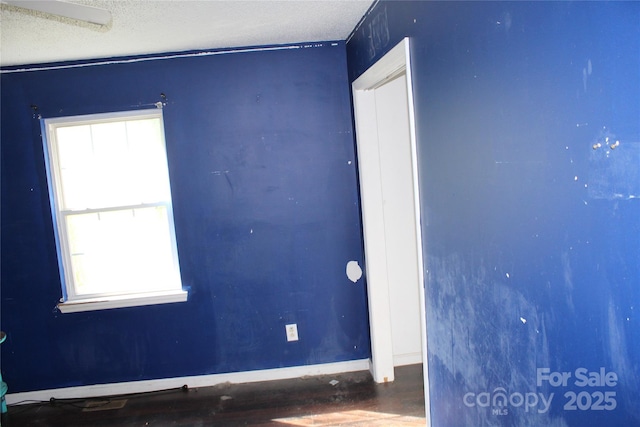5164 Ralph Winchester Rd, Lenoir, NC 28645 - spare room featuring a textured ceiling, wood finished floors, and baseboards