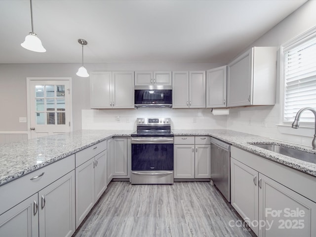 1315 Holshouser Rd, Rockwell, NC 28138 - kitchen with appliances with stainless steel finishes, a sink, light stone counters, and hanging light fixtures