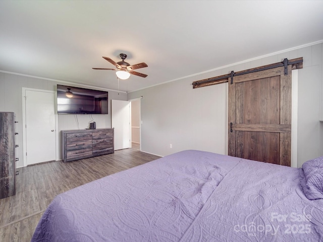 1315 Holshouser Rd, Rockwell, NC 28138 - bedroom with a barn door, crown molding, and wood finished floors