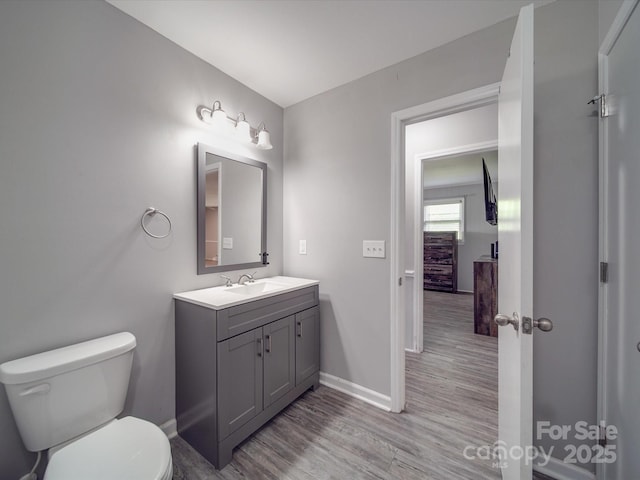 1315 Holshouser Rd, Rockwell, NC 28138 - half bath with toilet, baseboards, vanity, and wood finished floors