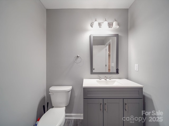 1315 Holshouser Rd, Rockwell, NC 28138 - bathroom featuring toilet, wood finished floors, vanity, and baseboards