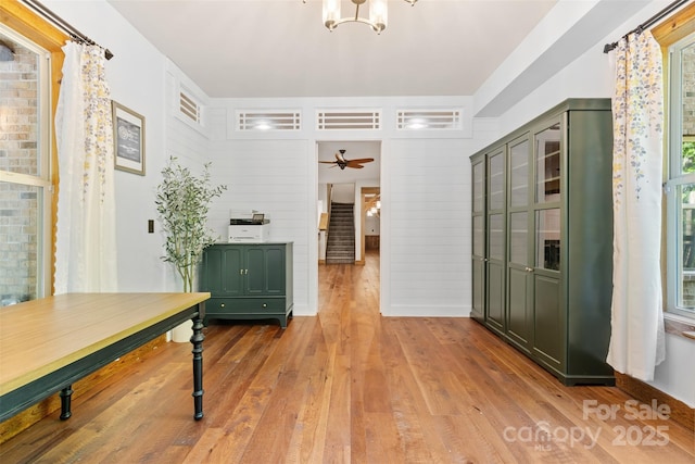 dining area featuring wood-type flooring, a chandelier, and ceiling fan