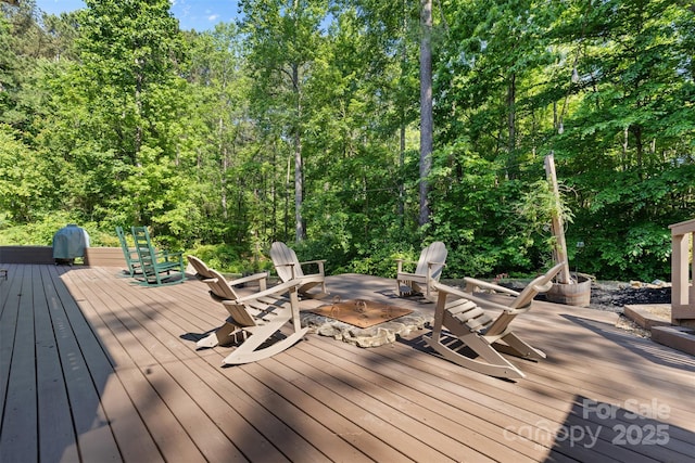 wooden deck with an outdoor fire pit