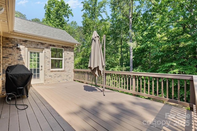 wooden terrace with a grill