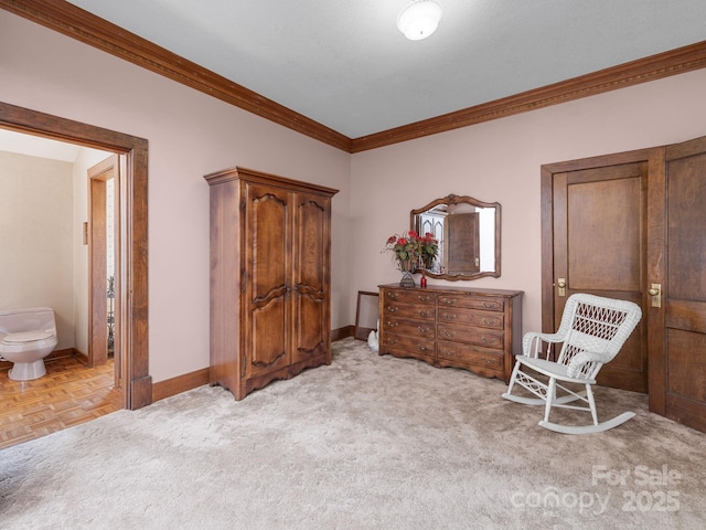 living area featuring crown molding and baseboards
