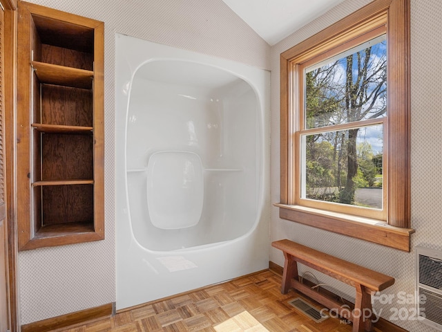 full bath with visible vents and lofted ceiling