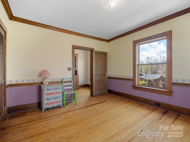 bedroom with light wood-style floors, a closet, baseboards, and ornamental molding