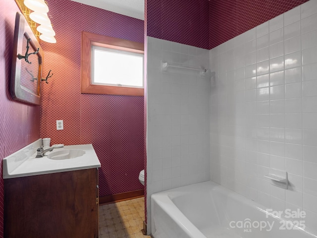 bathroom with toilet, tile patterned floors, vanity, and shower / bathtub combination