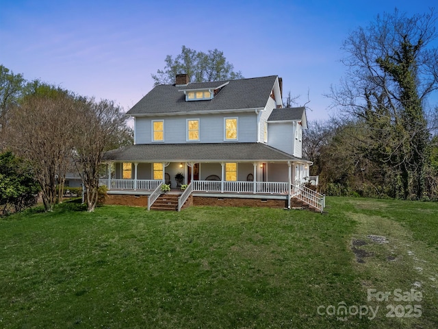 farmhouse-style home with roof with shingles, a porch, a chimney, and a front lawn