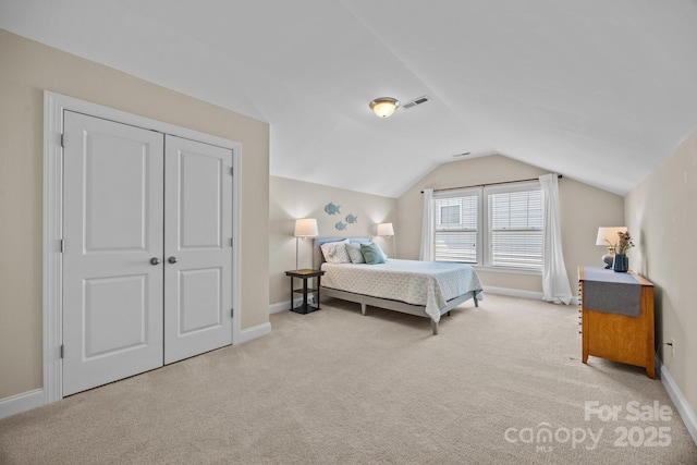 bedroom with visible vents, baseboards, vaulted ceiling, and carpet floors