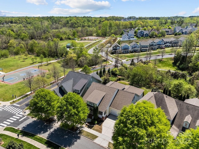 aerial view featuring a forest view and a residential view