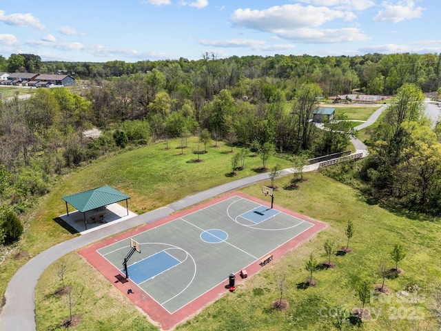 view of sport court with a wooded view, a gazebo, and community basketball court