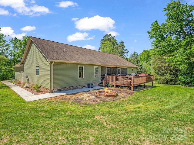 575 Hill Rd, Lincolnton, NC 28092 - back of property with a lawn, a fire pit, a wooden deck, and roof with shingles