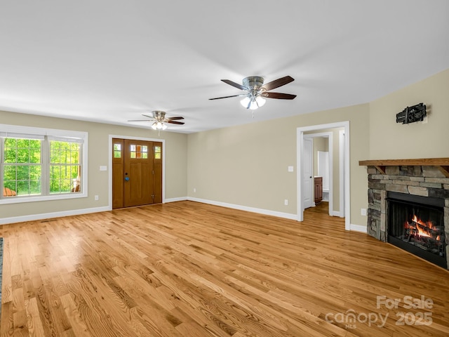 575 Hill Rd, Lincolnton, NC 28092 - unfurnished living room with baseboards, ceiling fan, a fireplace, and light wood finished floors