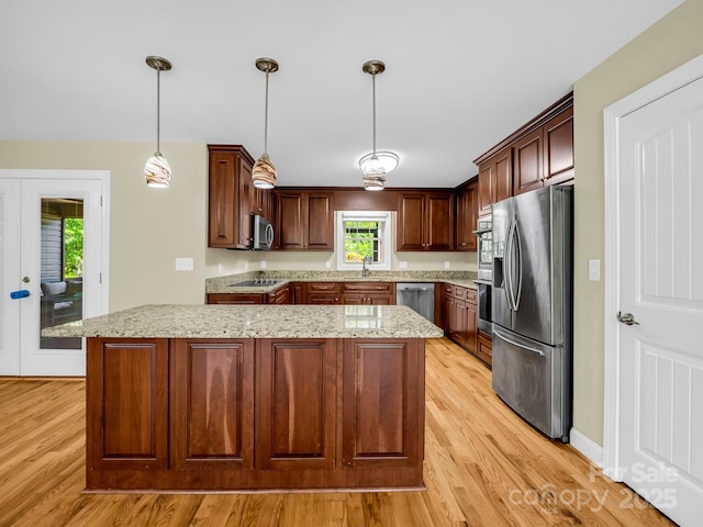 575 Hill Rd, Lincolnton, NC 28092 - kitchen with light wood-style floors, light stone counters, stainless steel appliances, and a sink
