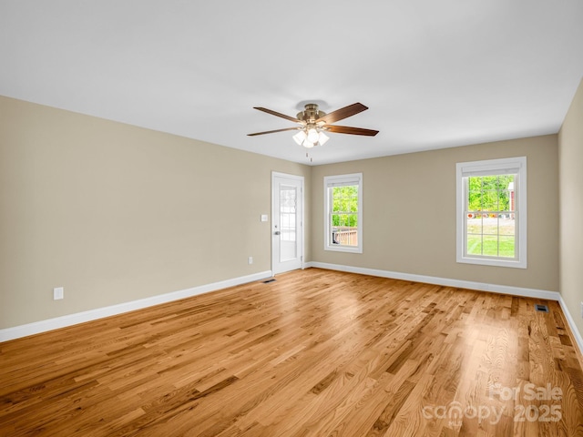 575 Hill Rd, Lincolnton, NC 28092 - spare room with baseboards, ceiling fan, a wealth of natural light, and light wood-style floors