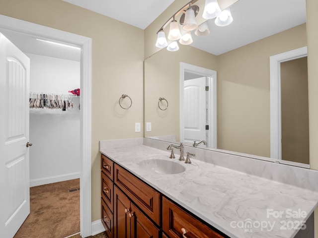575 Hill Rd, Lincolnton, NC 28092 - bathroom featuring vanity, baseboards, a spacious closet, and visible vents