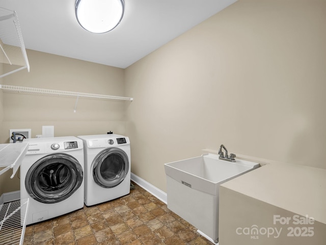 575 Hill Rd, Lincolnton, NC 28092 - laundry room with stone finish floor, laundry area, a sink, baseboards, and washer and dryer