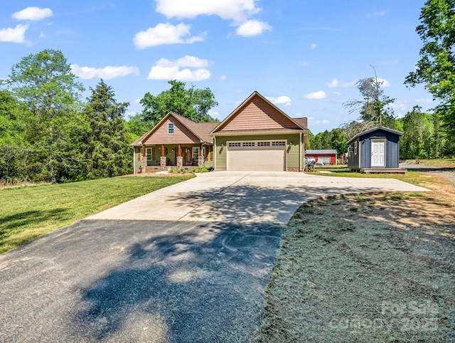 575 Hill Rd, Lincolnton, NC 28092 - craftsman house featuring a garage, a front lawn, driveway, a porch, and a storage shed