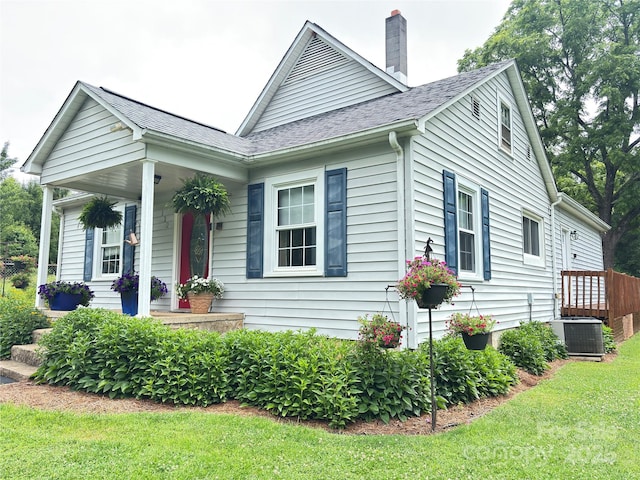 112 11th St NE, Hildebran, NC 28637 - view of side of home featuring covered porch, a chimney, a yard, and a shingled roof