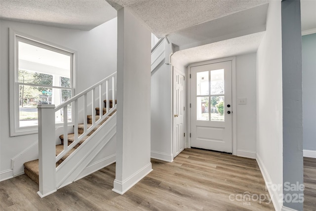 107 Maurice St, Monroe, NC 28112 - foyer entrance featuring a healthy amount of sunlight, stairway, and light wood finished floors
