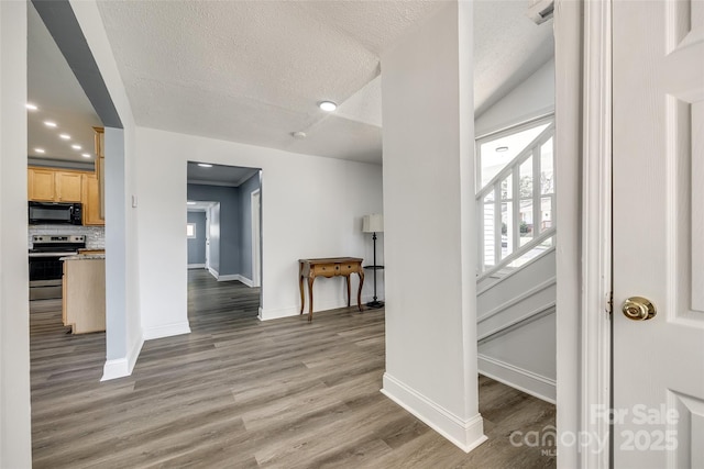 107 Maurice St, Monroe, NC 28112 - hall featuring light wood-style floors, recessed lighting, baseboards, and a textured ceiling