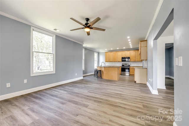 107 Maurice St, Monroe, NC 28112 - kitchen featuring ornamental molding, black microwave, open floor plan, stainless steel range with electric cooktop, and ceiling fan