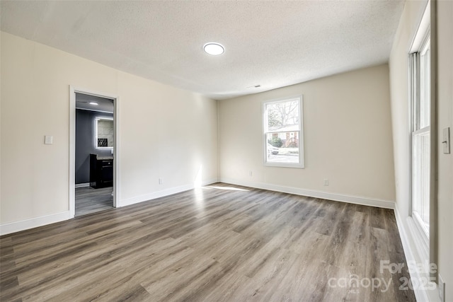 107 Maurice St, Monroe, NC 28112 - empty room with a textured ceiling, wood finished floors, and baseboards