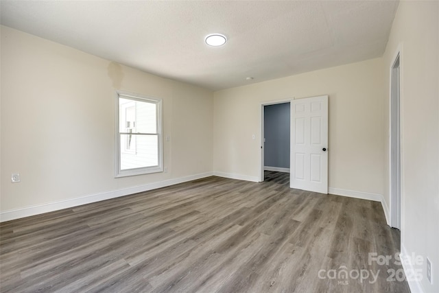 107 Maurice St, Monroe, NC 28112 - unfurnished room with baseboards, a textured ceiling, and wood finished floors