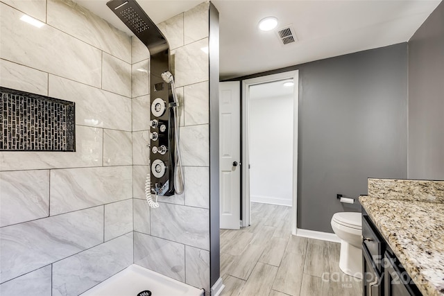 107 Maurice St, Monroe, NC 28112 - full bath with vanity, baseboards, toilet, visible vents, and a tile shower
