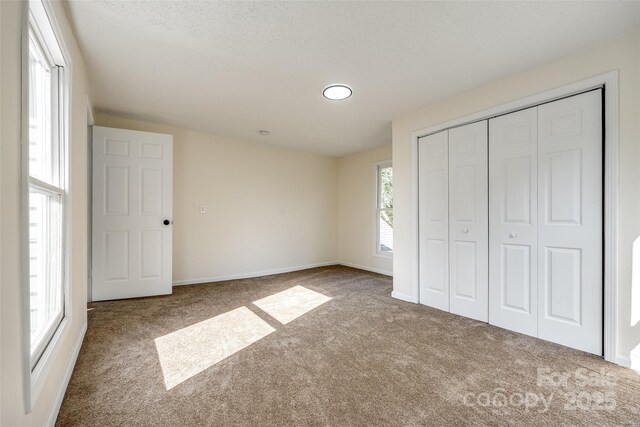 107 Maurice St, Monroe, NC 28112 - unfurnished bedroom with carpet, a closet, and baseboards