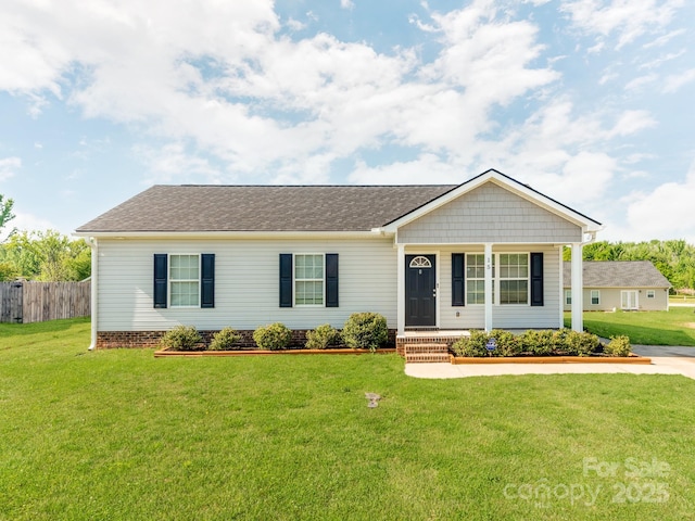 ranch-style home with fence, covered porch, and a front yard