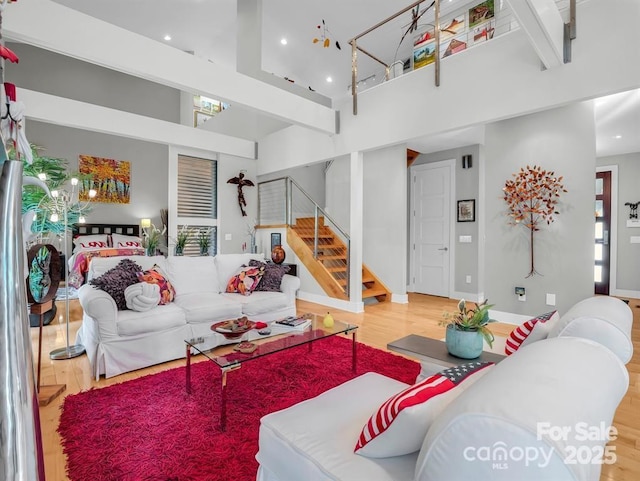 167 Trails End End, Lake Lure, NC 28746 - living area with stairway, a towering ceiling, baseboards, and wood finished floors
