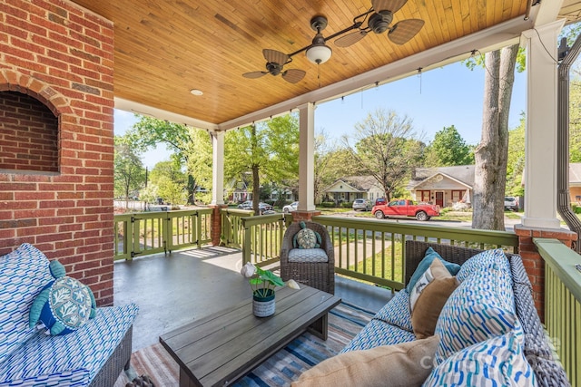 deck featuring outdoor lounge area and a ceiling fan