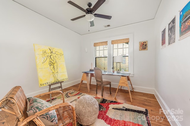 office area featuring visible vents, baseboards, a ceiling fan, and wood finished floors