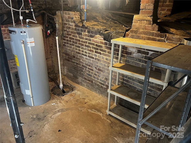 below grade area featuring brick wall and water heater