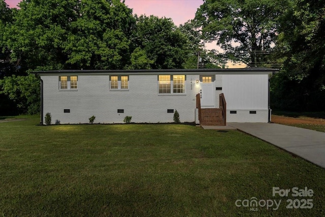 3423 Archer Ave, Charlotte, NC 28217 - view of front of house with crawl space, entry steps, a front lawn, and brick siding