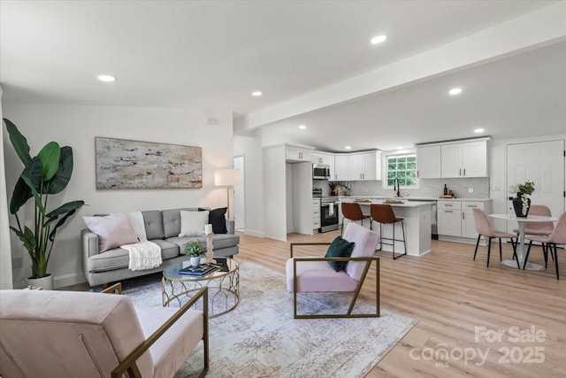 3423 Archer Ave, Charlotte, NC 28217 - living area with light wood finished floors, recessed lighting, and baseboards