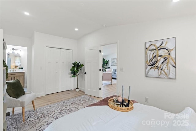 3423 Archer Ave, Charlotte, NC 28217 - bedroom with light wood-style flooring, vaulted ceiling, recessed lighting, a closet, and ensuite bath