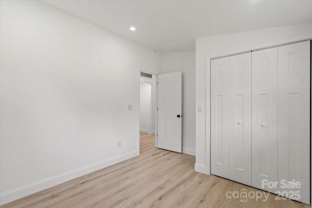 3423 Archer Ave, Charlotte, NC 28217 - unfurnished bedroom with wood finished floors, baseboards, a closet, and recessed lighting