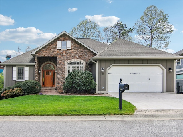 view of front of house featuring board and batten siding, a front lawn, an attached garage, a shingled roof, and concrete driveway