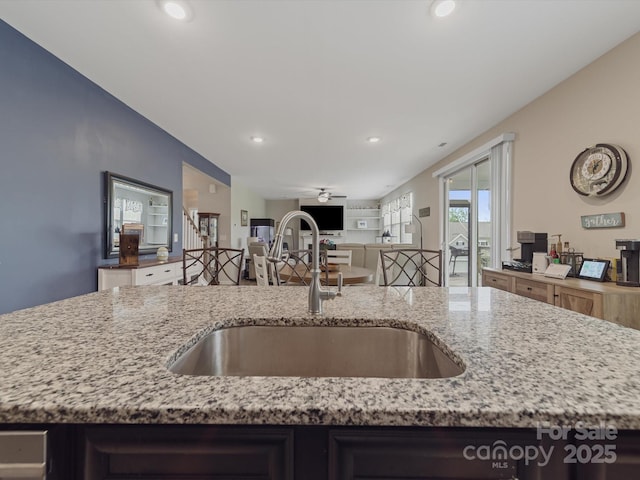 807 Oak Manor Dr SE, Concord, NC 28025 - kitchen featuring open floor plan, a sink, light stone counters, and ceiling fan