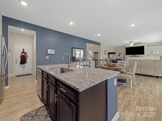 807 Oak Manor Dr SE, Concord, NC 28025 - kitchen featuring a sink, light wood-type flooring, appliances with stainless steel finishes, a ceiling fan, and dark brown cabinetry