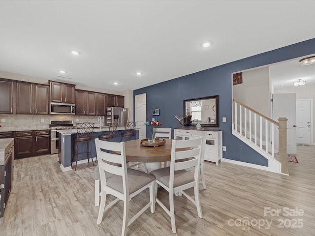 807 Oak Manor Dr SE, Concord, NC 28025 - dining area featuring recessed lighting, stairs, and light wood-type flooring