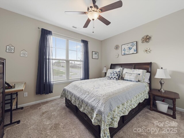 807 Oak Manor Dr SE, Concord, NC 28025 - bedroom with visible vents, baseboards, a ceiling fan, and light colored carpet