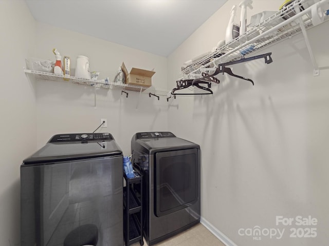 807 Oak Manor Dr SE, Concord, NC 28025 - laundry area featuring light tile patterned floors, washing machine and clothes dryer, laundry area, and baseboards