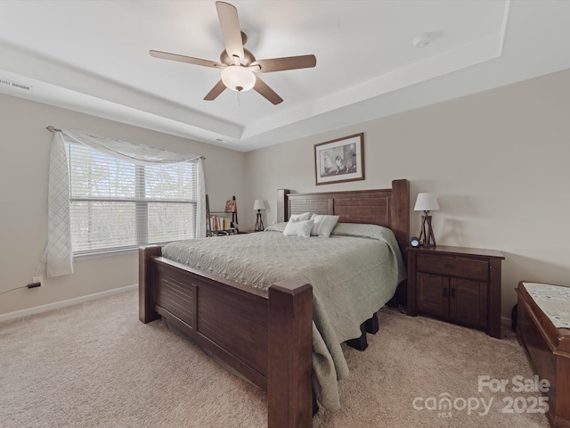 807 Oak Manor Dr SE, Concord, NC 28025 - bedroom with baseboards, visible vents, a tray ceiling, and light colored carpet