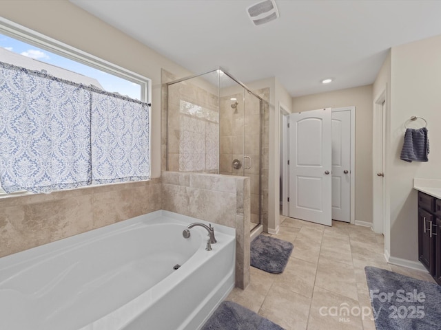 807 Oak Manor Dr SE, Concord, NC 28025 - full bath featuring visible vents, a bath, a shower stall, and vanity
