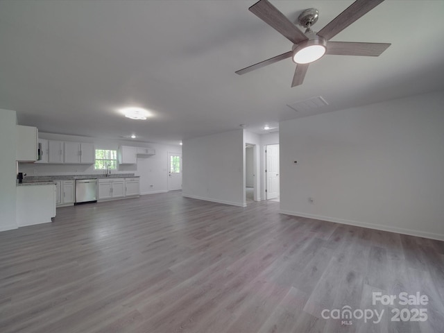 1241 Pitts Rd, Chester, SC 29706 - unfurnished living room with a sink, ceiling fan, light wood-style flooring, baseboards, and visible vents
