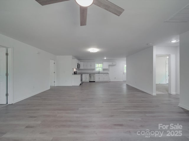 1241 Pitts Rd, Chester, SC 29706 - unfurnished living room with baseboards, a ceiling fan, and light wood-type flooring
